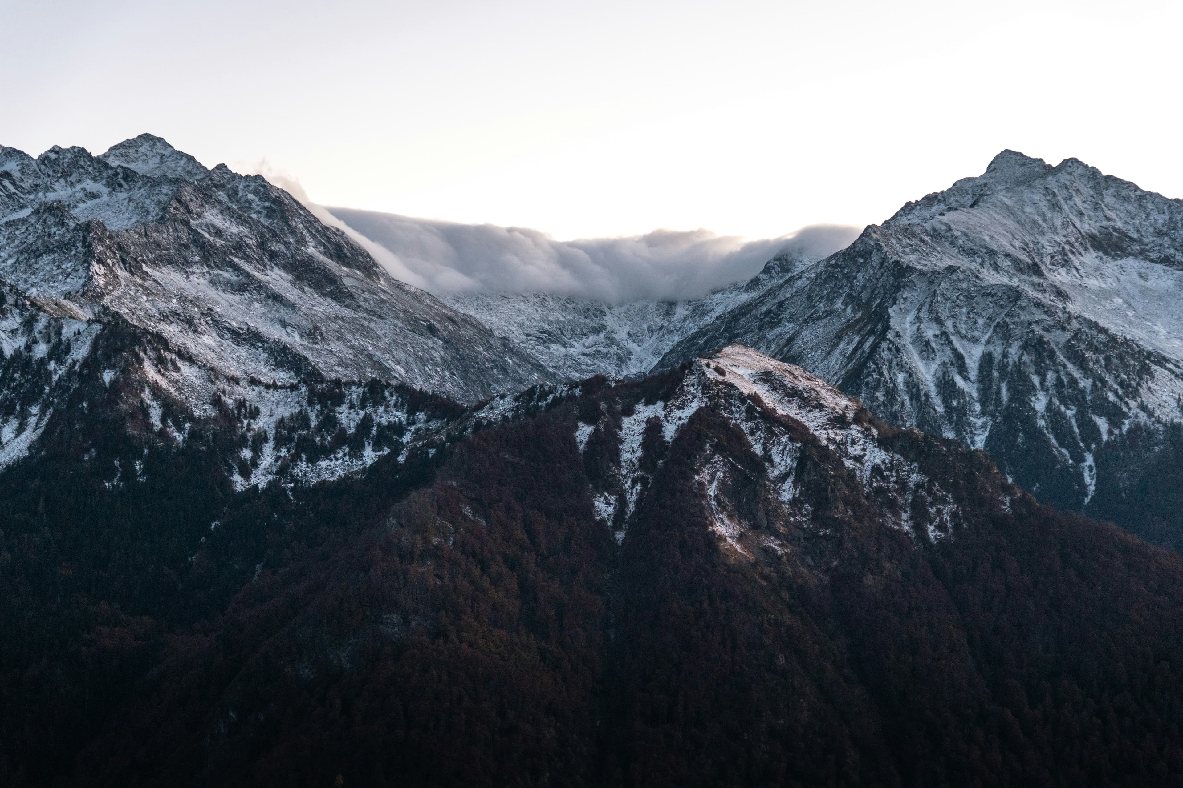 Dark snowy mountain range seen from above